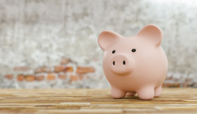 piggy-bank-on-a-table-in-front-of-a-brick-wall